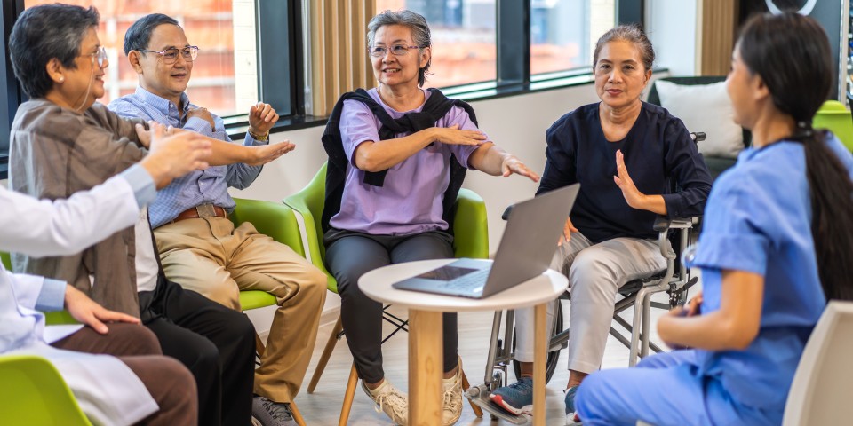 Portrait of asian woman physiotherapist trainer carer help physical and discussing consulting with group asian senior patient by doing yoga workout exercises in rehabilitation at hospital.healthcare
