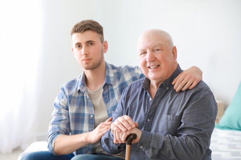 Caregiver with senior man in nursing home